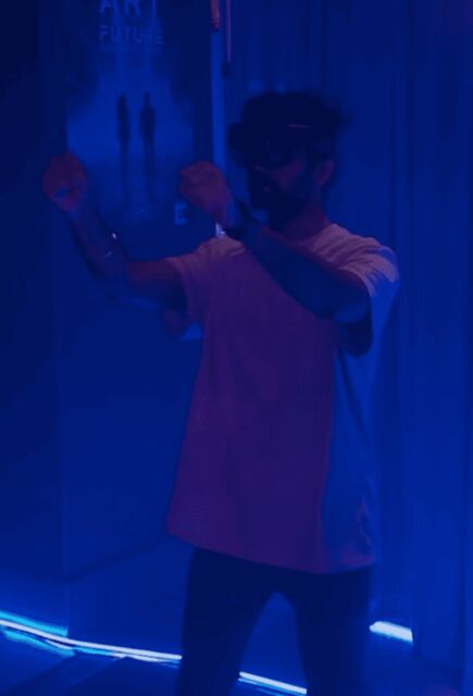 Apoorv wearing a HoloLens 2 in a blue-lit lab