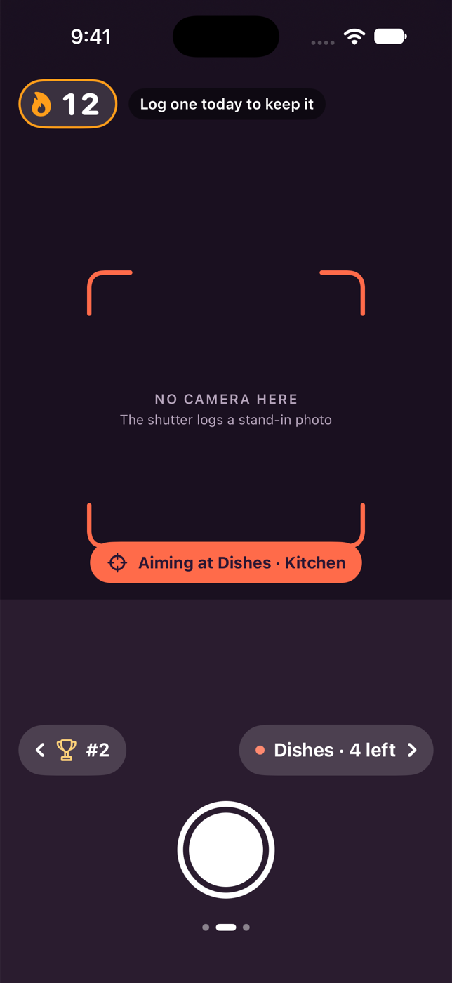 Version 0.2.0 camera screen from the first design pass: plum and coral palette, reticle and an Aiming at pill